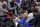 Oklahoma City Thunder guard Andre Roberson fist-bumps a fan as he is carted off after slipping during the second half of the team's NBA basketball game against the Detroit Pistons, Saturday, Jan. 27, 2018, in Detroit. (AP Photo/Carlos Osorio)