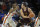 Loyola of Chicago center Cameron Krutwig (25) looks to pass around Florida forward Keith Stone (25) during the second half of an NCAA college basketball game in Gainesville, Fla., Wednesday, Dec. 6, 2017. Loyola of Chicago won 65-59. (AP Photo/Ron Irby)