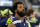 FILE - In this Dec. 24, 2017, file photo, Seattle Seahawks defensive end Michael Bennett (72) watches his team play the Dallas Cowboys during an NFL football game in Arlington, Texas. A Harris County, Texas, grand jury on Friday, March 23, 20187, indicted Philadelphia Eagles defensive end Michael Bennett on a felony count of injury to the elderly for injuring a 66-year-old paraplegic who was working at NRG Stadium in Houston to control access to the field at Super Bowl 51, prosecutors said. The Eagles earlier this month acquired Bennett from the Seahawks.  (AP Photo/Michael Ainsworth, File)