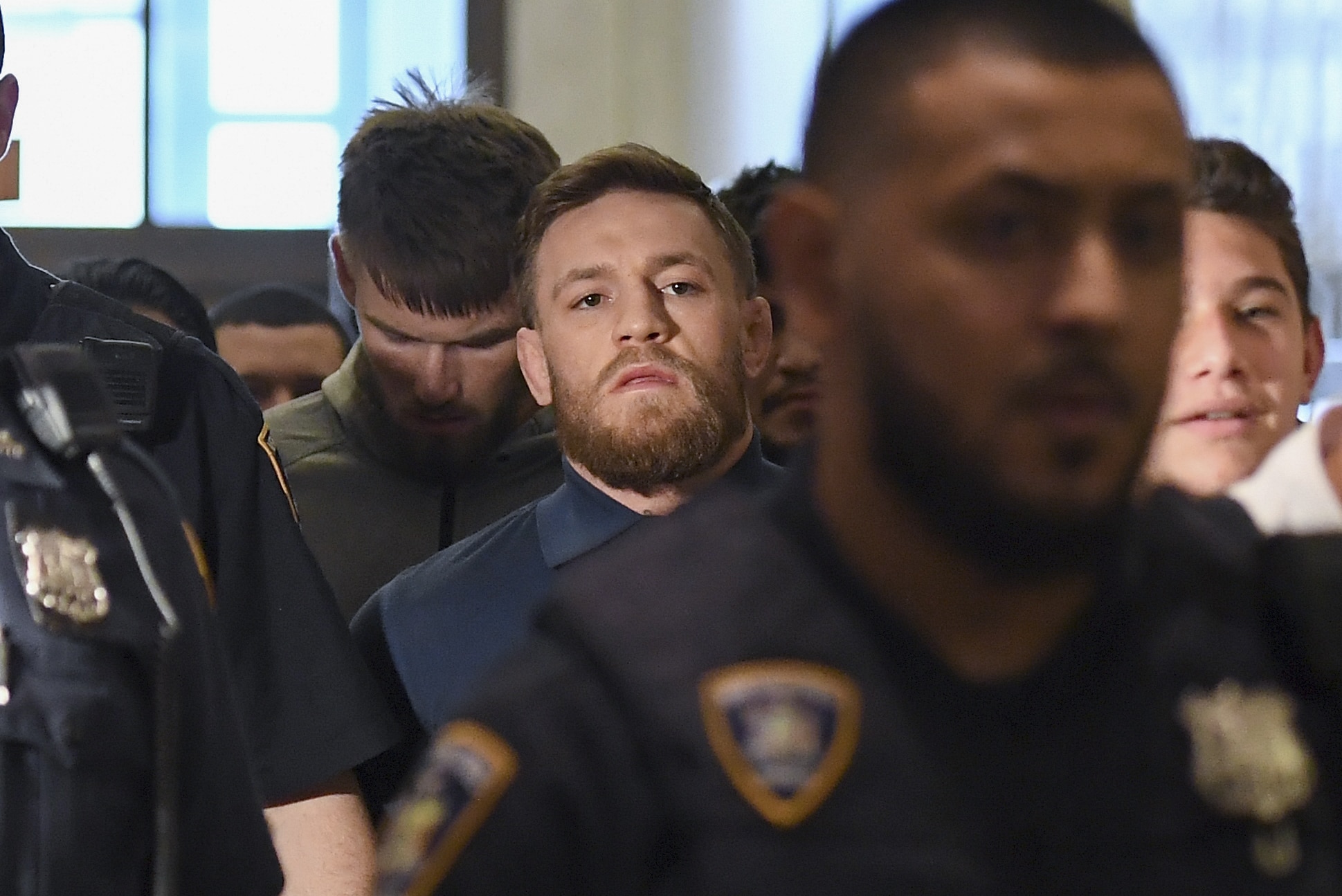 Irish Mixed Martial Arts fighter Conor McGregor leaves the Kings County (Brooklyn) Criminal Court on April 6, 2018 in New York.
Irish Mixed Martial Arts fighter Conor McGregor was charged with assault and criminal mischief by New York police on April 6, 2018 and was due to appear in court. The 29-year-old superstar reportedly surrendered at a Brooklyn police station late Thursday after allegedly attacking a shuttle bus loaded with fellow mixed martial arts fighters attending a New York media event at the Barclays Center stadium.Video footage showed McGregor hurling a dolly through a side window of the bus as it moved slowly in a parking lot at the stadium in Brooklyn.
/ AFP PHOTO / ANGELA WEISS (Photo credit should read ANGELA WEISS/AFP/Getty Images)