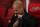 STOKE ON TRENT, ENGLAND - MARCH 12: Manchester City manager Pep Guardiola removes his yellow ribbon in support of jailed Catalan independence leaders which he was fined £20,000 for wearing by the FA during the Premier League match between Stoke City and Manchester City at Bet365 Stadium on March 12, 2018 in Stoke on Trent, England. (Photo by Matthew Ashton - AMA/Getty Images)