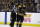 Boston Bruins left wing Brad Marchand (63) is escorted to the penalty box during the second period of Game 3 of an NHL second-round hockey playoff series against the Tampa Bay Lightning in Boston, Wednesday, May 2, 2018. (AP Photo/Charles Krupa)
