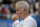 FILE - In a  Saturday June 18, 2016 file photo, John McEnroe, Coach to Canada's Milos Raconic, looks across the court as Raconic plays Australia's Bernard Tomic during their semifinal tennis match on the sixth day of the Queen's Championships London. McEnroe wants to see players get fed up that they can't break through against Roger Federer and Rafael Nadal, that they remain stuck behind Novak Djokovic and Andy Murray heading into Wimbledon.(AP Photo/Tim Ireland, File)