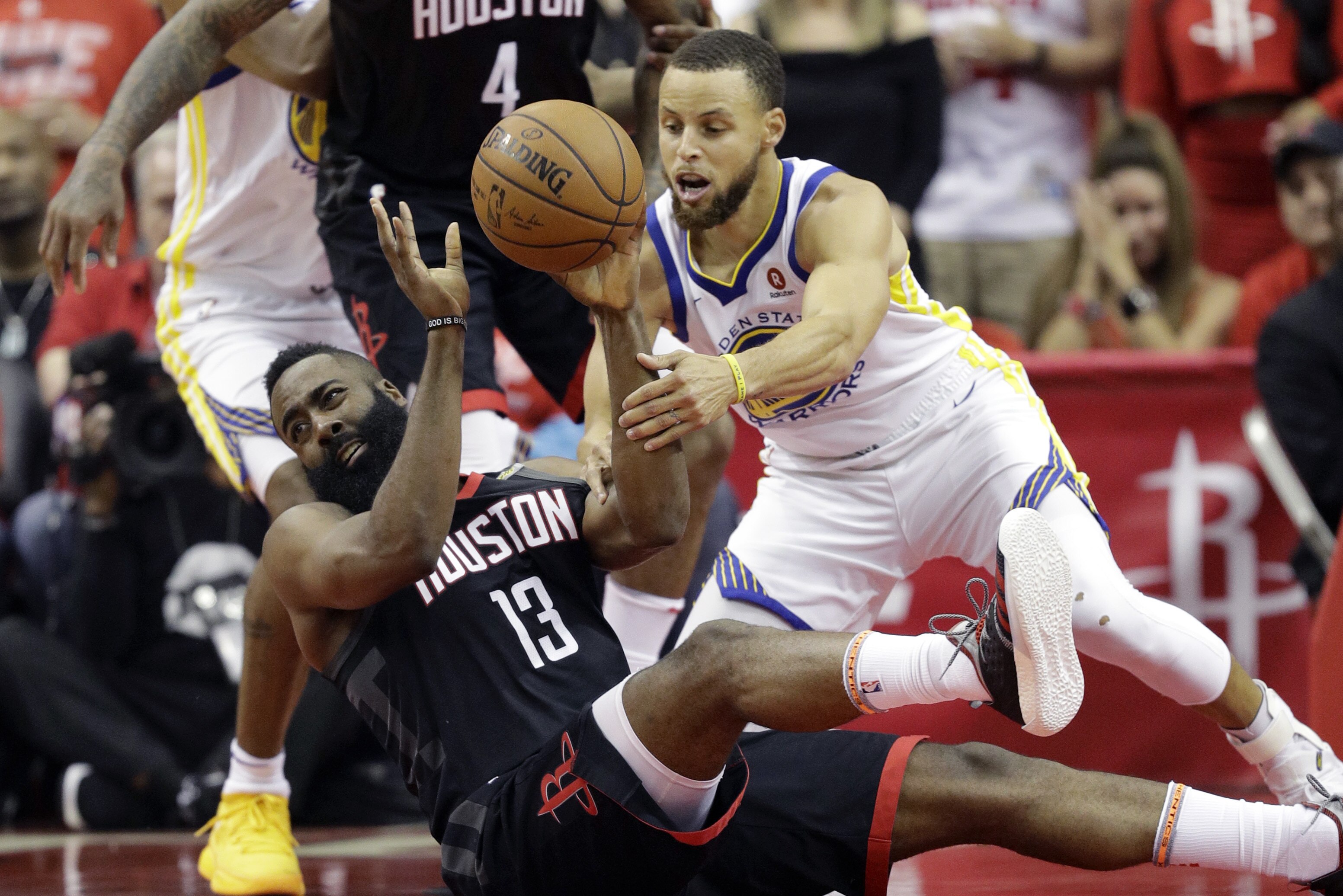 Houston Rockets guard James Harden (13) and Golden State Warriors guard Stephen Curry (30) scramble for a loose ball during the first half in Game 7 of the NBA basketball Western Conference finals, Monday, May 28, 2018, in Houston. (AP Photo/David Phillip)