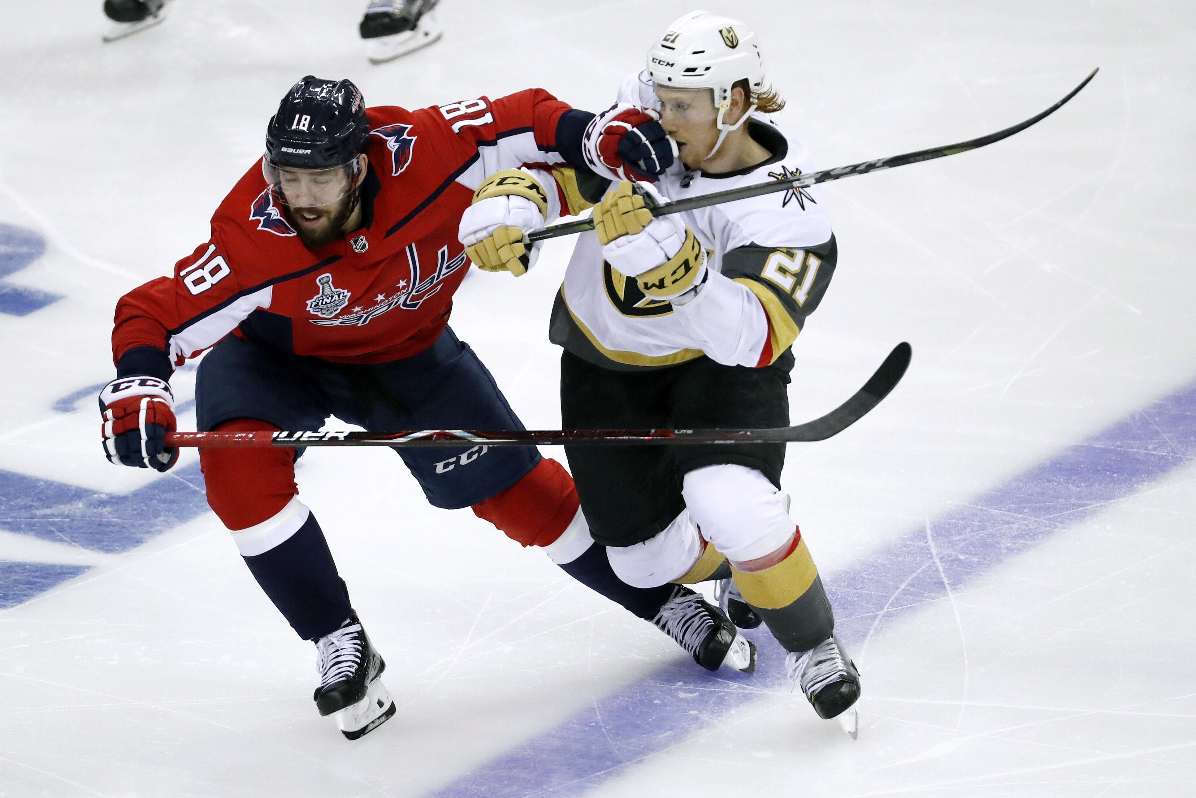Washington Capitals forward Chandler Stephenson (18) contends with Vegas Golden Knights forward Cody Eakin (21) during the third period in Game 3 of the NHL hockey Stanley Cup Final, Saturday, June 2, 2018, in Washington. (AP Photo/Pablo Martinez Monsivais)