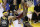 Cleveland Cavaliers forward LeBron James (23) shoots between Golden State Warriors center JaVale McGee (1) and forward Draymond Green during the second half of Game 2 of basketball's NBA Finals in Oakland, Calif., Sunday, June 3, 2018. (AP Photo/Marcio Jose Sanchez)