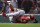 Los Angeles Angels pitcher Jake Jewell rolls on the field after injuring his right ankle while covering home after a wild pitch during the eighth inning of a baseball game against the Boston Red Sox at Fenway Park in Boston, Wednesday, June 27, 2018. Jewell injured his right ankle on the play. (AP Photo/Charles Krupa)