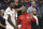 FILE - In this Wednesday, Oct. 18, 2017, file photo, Houston Rockets center Clint Capela (15) and guard Chris Paul talk on the sideline during the second half of an NBA basketball game against the Sacramento Kings in Sacramento, Calif. Rockets coach Mike D'Antoni on Saturday, Oct. 21, 2017, that the team will hold Paul out until the knee is completely healed. The team has not offered any specifics on the injury, other than the knee is bruised. (AP Photo/Steve Yeater, File)