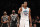 Charlotte Hornets center Dwight Howard (12) reacts during the second half of the team's NBA basketball game against the Brooklyn Nets on Wednesday, March 21, 2018, in New York. Brooklyn Nets guard Allen Crabbe (33) and forward Quincy Acy (13) watch a video replay. The Hornets won 111-105. (AP Photo/Kathy Willens)