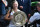 Germany's Angelique Kerber carries the winner's trophy, the Venus Rosewater Dish, as she leaves the court after her women's singles final victory over US player Serena Williams on the twelfth day of the 2018 Wimbledon Championships at The All England Lawn Tennis Club in Wimbledon, southwest London, on July 14, 2018. - Kerber won the match 6-3, 6-3. (Photo by Glyn KIRK / AFP) / RESTRICTED TO EDITORIAL USE        (Photo credit should read GLYN KIRK/AFP/Getty Images)
