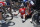 Australia's Richie Porte, right, receives medical attention as he sits on the road with Belgium's Jens Keukeleire, center, after crashing during the ninth stage of the Tour de France cycling race over 156.5 kilometers (97.2 miles) with start in Arras and finish in Roubaix, France, Sunday, July 15, 2018. Porte quit the race after the crash. (AP Photo/Christophe Ena )