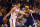 PHOENIX, AZ - APRIL 08:  Alex Len #21 of the Phoenix Suns handles the ball against JaVale McGee #1 of the Golden State Warriors during the first half of the NBA game at Talking Stick Resort Arena on April 8, 2018 in Phoenix, Arizona.  NOTE TO USER: User expressly acknowledges and agrees that, by downloading and or using this photograph, User is consenting to the terms and conditions of the Getty Images License Agreement.  (Photo by Christian Petersen/Getty Images)