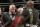 Brock Lesnar, left, taunts Daniel Cormier after Cormier's heavyweight title mixed martial arts bout at against Stipe Miocic at UFC 226, Saturday, July 7, 2018, in Las Vegas. (AP Photo/John Locher)