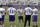Minnesota Vikings tight ends coach Clancy Barone, center, talks with offensive linemen during walk-throughs as training camp opened for rookies and certain veterans at the NFL football team's complex Wednesday, July 25, 2018, in Eagan, Minn. Tony Sparano, the team's head offensive line coach, died on Sunday of a heart condition. (AP Photo/Jim Mone)