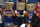 New York Knicks' fans stand during the second half of an NBA basketball game against the New Orleans Pelicans in New Orleans, Tuesday, Dec. 9, 2014. No team has more losses than the Knicks. Only Detroit has as many. Some fans in Knicks jerseys wore brown paper grocery bags over their heads, as fans of the “Aints” once did in the Superdome next door when the Saints were at their worst. (AP Photo/Jonathan Bachman)
