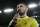 In this photo taken on Friday, Oct. 19, 2018, UFC lightweight champion Khabib Nurmagomedov delivers a speech to support Anzhi Makhachkala's players before the Russian Primer League soccer match between CSKA Moscow and Anzhi Makhachkala in Makhachkala, Russia. From 2011 to 2013, Anzhi’s vast spending made waves around the world as the likes of Samuel Eto’o and Roberto Carlos came to play in a region until then better known for its Islamist insurgency, but now Anzhi Makhachkala is struggling to survive. (AP Photo/Denis Tyrin)