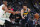 Denver Nuggets guard Jamal Murray, right, drives the lane as Boston Celtics center Al Horford, left, and guard Kyrie Irving, center, defend in the first half of an NBA basketball game Monday, Nov. 5, 2018, in Denver. (AP Photo/David Zalubowski)