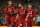 Liverpool's Egyptian midfielder Mohamed Salah (2nd R) celebrates with Liverpool's Senegalese striker Sadio Mane (2nd L) and Liverpool's Brazilian midfielder Fabinho (L) after scoring their third goal from the penalty spot during the UEFA Champions League group C football match between Liverpool and Red Star Belgrade at Anfield in Liverpool, north west England on October 24, 2018. (Photo by Oli SCARFF / AFP)        (Photo credit should read OLI SCARFF/AFP/Getty Images)