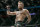 Conor McGregor walks in the cage before fighting Khabib Nurmagomedov in a lightweight title mixed martial arts bout at UFC 229 in Las Vegas, Saturday, Oct. 6, 2018. (AP Photo/John Locher)