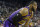 Los Angeles Lakers forward LeBron James bends over after straining his groin during the second half of the team's NBA basketball game against the Golden State Warriors on Tuesday, Dec. 25, 2018, in Oakland, Calif. The Lakers won 127-101. (AP Photo/Tony Avelar)