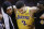 Los Angeles Lakers guard Lonzo Ball, center, is carried off the court by Michael Beasley, left, and Lance Stephenson after Ball sustained an injury during the second half of the team's NBA basketball game against the Houston Rockets, Saturday, Jan. 19, 2019, in Houston. (AP Photo/Eric Christian Smith)