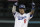 Los Angeles Dodgers' Manny Machado reacts after hitting a double during the first inning of Game 3 of the National League Championship Series baseball game Monday, Oct. 15, 2018, in Los Angeles. (AP Photo/Jae Hong)