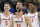 Virginia's Ty Jerome (11) celebrates with teammates Kyle Guy (5) and De'Andre Hunter (12) during overtime of the men's NCAA Tournament college basketball South Regional final game against Purdue, Saturday, March 30, 2019, in Louisville, Ky. Virginia won 80-75. (AP Photo/Timothy D. Easley)