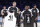 CORRECTS TO DWYANE, NOT SWAYNE - Team Giannis' Dirk Nowitzki, of the Dallas Mavericks, and Team LeBron's Dwyane Wade, of the Miami Heat, are given jerseys during the second half of an NBA All-Star basketball game, Sunday, Feb. 17, 2019, in Charlotte, N.C. The Team LeBron won 178-164. (AP Photo/Chuck Burton)