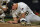 Pittsburgh Pirates relief pitcher Nick Burdi, right, holds his right arm after delivering a pitch during the eighth inning of a baseball game against the Arizona Diamondbacks in Pittsburgh, Monday, April 22, 2019. Burdi left the game with a team trainer, and the Diamondbacks won 12-4. (AP Photo/Gene J. Puskar)