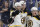 Boston Bruins defenseman Brandon Carlo, center, celebrates with Charlie Coyle (13) and Torey Krug (47) after Carlo scored a goal against the St. Louis Blues during the third period of Game 6 of the NHL hockey Stanley Cup Final Sunday, June 9, 2019, in St. Louis. (AP Photo/Jeff Roberson)