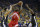 Toronto Raptors forward Kawhi Leonard (2) shoots between Golden State Warriors guard Klay Thompson, left, and center Kevon Looney (5) during the first half of Game 4 of basketball's NBA Finals in Oakland, Calif., Friday, June 7, 2019. (AP Photo/Ben Margot)
