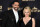 Marseille's defender Adil Rami (L) and US actress Pamela Anderson arrive to take part in a TV show on May 19, 2019 in Paris, as part of the 28th edition of the UNFP (French National Professional Football players Union) trophy ceremony. (Photo by FRANCK FIFE / AFP)        (Photo credit should read FRANCK FIFE/AFP/Getty Images)