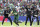Pakistan's batsman Babar Azam, second from left, makes a run after playing a shot as New Zealand's wicketkeeper Tom Latham, far right, with teammates react during the Cricket World Cup match between New Zealand and Pakistan at the Edgbaston Stadium in Birmingham, England, Wednesday, June 26, 2019. (AP Photo/Rui Vieira)