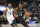 San Antonio Spurs guard Lonnie Walker IV (18) drives as Memphis Grizzlies guard Jevon Carter (3) trails during the first half of an NBA summer league basketball game Thursday, July 5, 2018, in Salt Lake City. (AP Photo/Rick Bowmer)