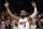 Miami Heat guard Dwyane Wade (3) acknowledges the crowd's cheers after playing in the final NBA basketball game of his career, against the Brooklyn Nets, Wednesday, April 10, 2019, in New York. (AP Photo/Kathy Willens)