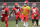 Kansas City Chiefs running backs Anthony Sherman (42), Carlos Hyde (34) and Damien Williams (26) stretch with quarterback Patrick Mahomes (15) during a workout at the NFL football team's training facility Thursday, June 13, 2019, in Kansas City, Mo. (AP Photo/Charlie Riedel)