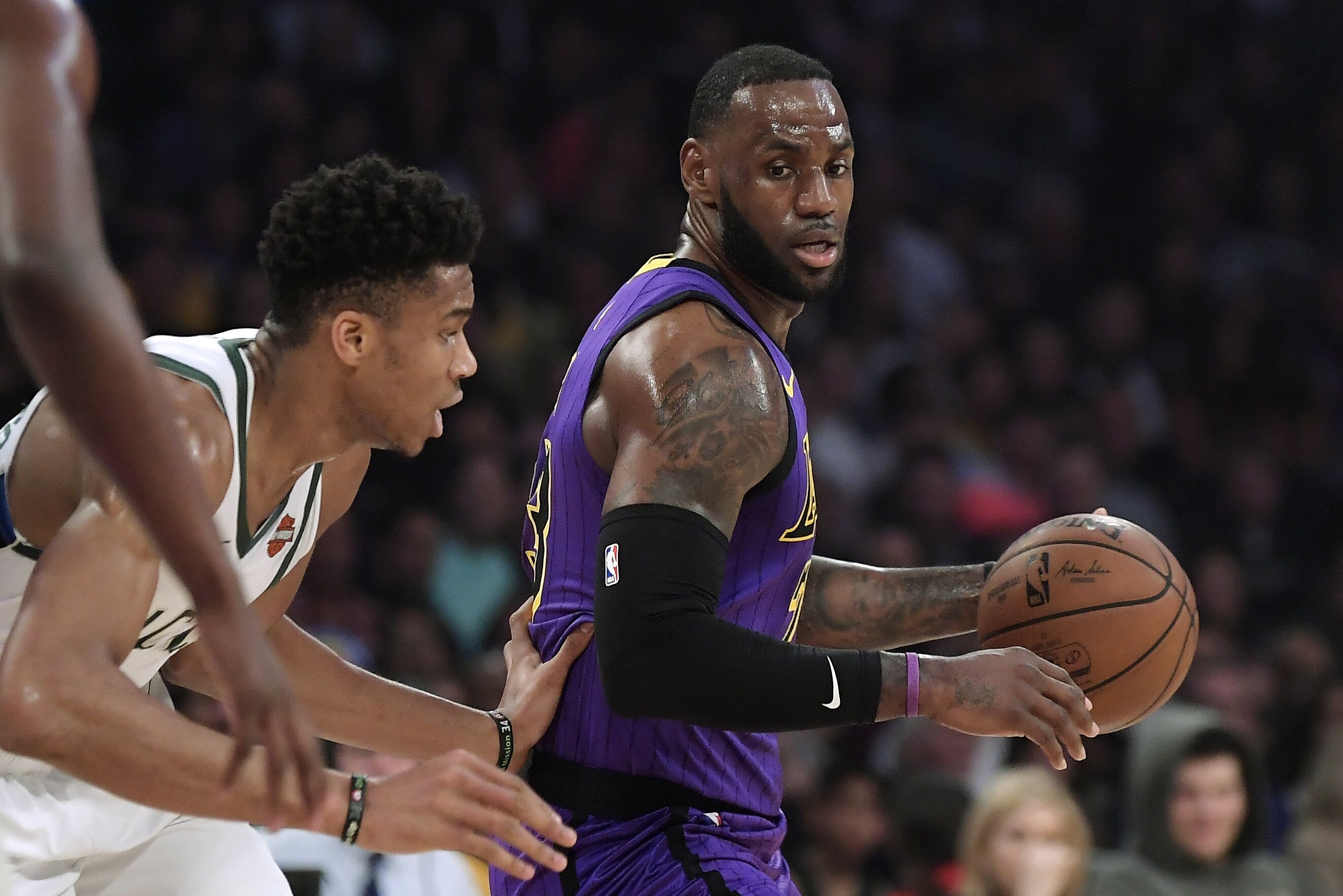 Los Angeles Lakers forward LeBron James, right, tries to move past Milwaukee Bucks forward Giannis Antetokounmpo during the first half of an NBA basketball game Friday, March 1, 2019, in Los Angeles. (AP Photo/Mark J. Terrill)