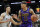 Los Angeles Lakers' Michael Beasley (11) drives against San Antonio Spurs' Derrick White during the first half of an NBA basketball game Friday, Dec. 7, 2018, in San Antonio. (AP Photo/Darren Abate)