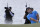 Patrick Reed hits out of a bunker on the fourth hole in the final round of the Northern Trust golf tournament at Liberty National Golf Course, Sunday, Aug. 11, 2019, in Jersey City, N.J. (AP Photo/Mark Lennihan)