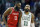 Houston Rockets' James Harden (13) follows Boston Celtics' Kyrie Irving (11) upcourt following a timeout during the fourth quarter of an NBA basketball game in Boston, Thursday, Dec. 28, 2017. (AP Photo/Michael Dwyer)