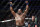 Daniel Cormier reacts after defeating Stipe Miocic in a heavyweight title mixed martial arts bout at UFC 226, Saturday, July 7, 2018, in Las Vegas. (AP Photo/John Locher)