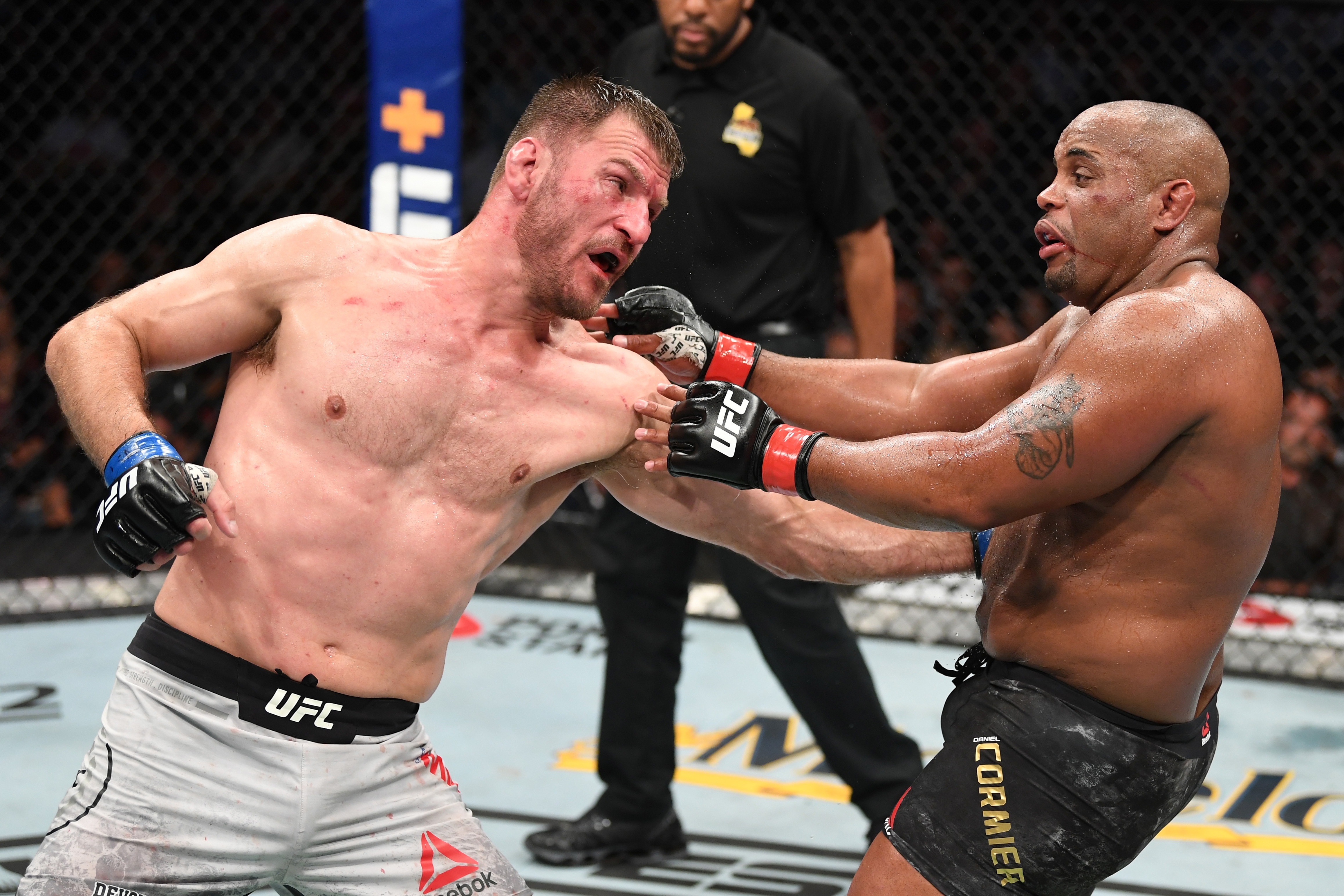 ANAHEIM, CALIFORNIA - AUGUST 17: (L-R) Stipe Miocic punches Daniel Cormier in their heavyweight championship bout during the UFC 241 event at the Honda Center on August 17, 2019 in Anaheim, California. (Photo by Josh Hedges/Zuffa LLC/Zuffa LLC via Getty Images)