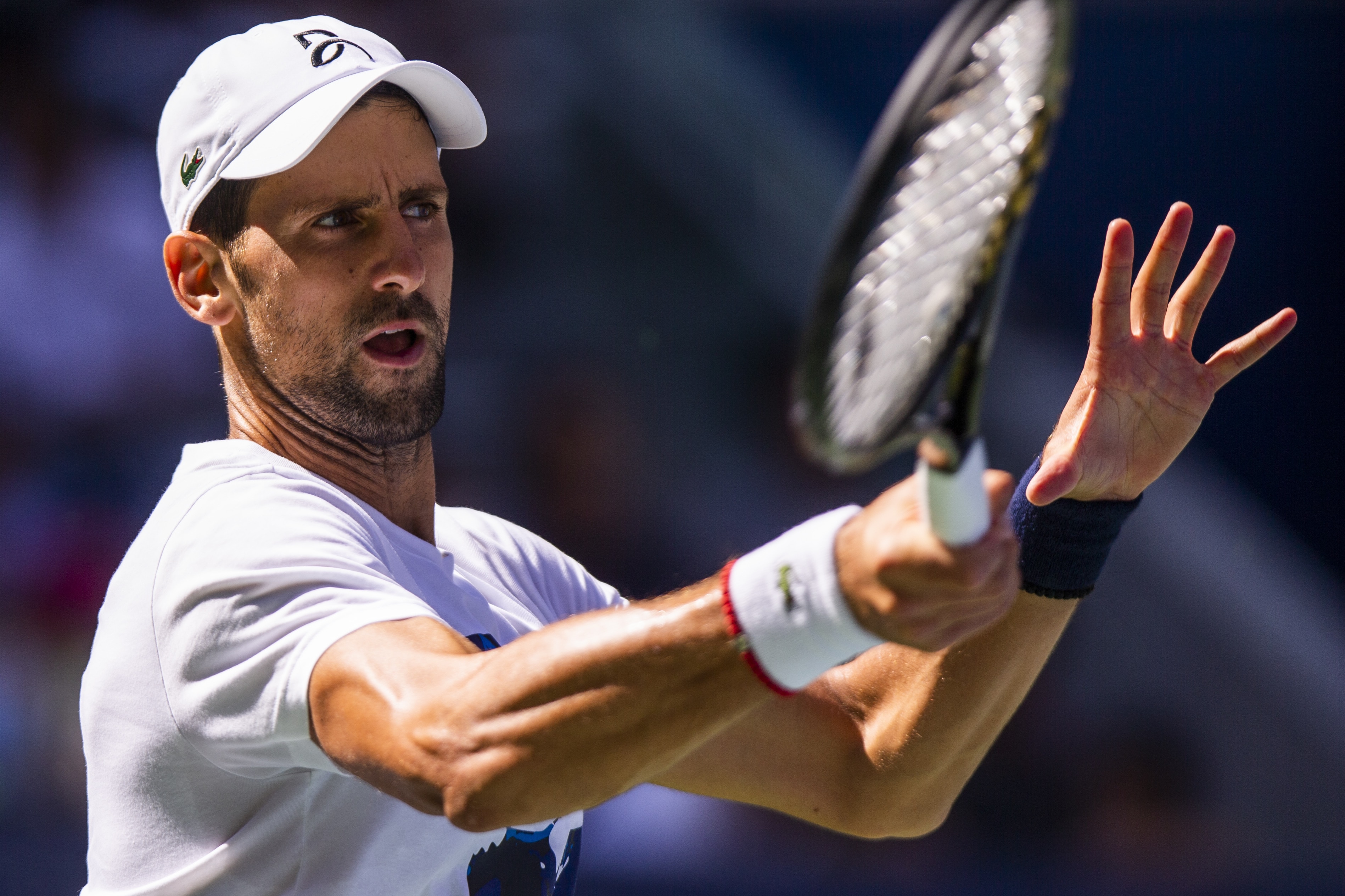 Novak Djokovic, of Serbia, returns the ball as he practices for the U.S. Open tennis tournament Saturday, Aug. 24, 2019, in New York. (AP Photo/Eduardo Munoz Alvarez)