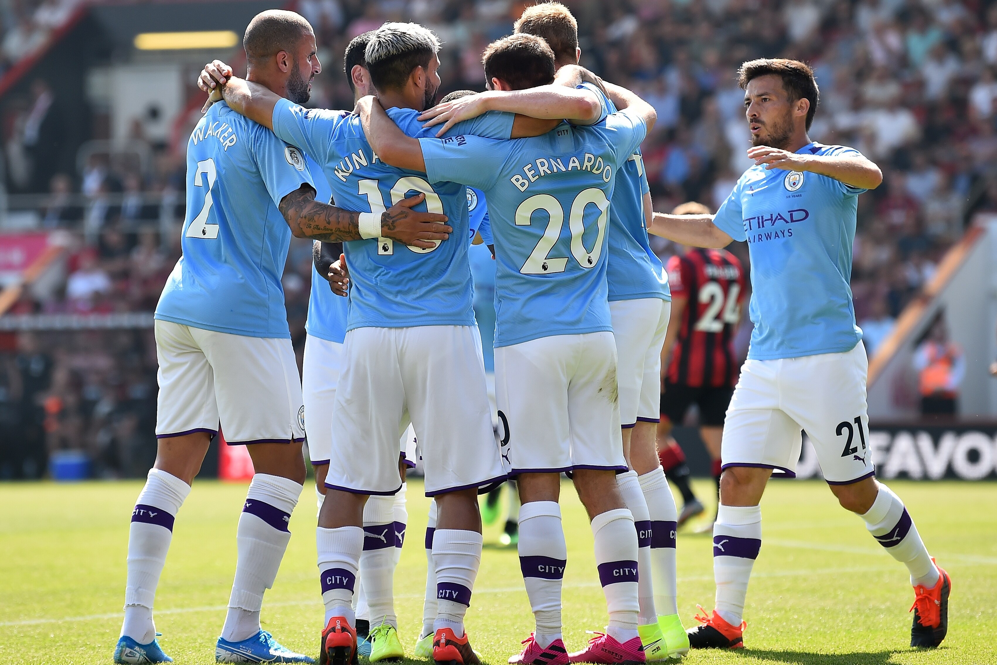 Manchester City's Argentinian striker Sergio Aguero (3L) celebrates scoring the opening goal during the English Premier League football match between Bournemouth and Manchester City at the Vitality Stadium in Bournemouth, southern England on August 25, 2019. (Photo by Glyn KIRK / AFP) / RESTRICTED TO EDITORIAL USE. No use with unauthorized audio, video, data, fixture lists, club/league logos or 'live' services. Online in-match use limited to 120 images. An additional 40 images may be used in extra time. No video emulation. Social media in-match use limited to 120 images. An additional 40 images may be used in extra time. No use in betting publications, games or single club/league/player publications. / (Photo credit should read GLYN KIRK/AFP/Getty Images)