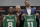 Newly acquired Boston Celtics guard Kemba Walker (8) and center Enes Kanter (11) pose with their team jerseys at the Celtics' basketball practice facility, Wednesday, July 17, 2019, in Boston. Looking on is team general manager Danny Ainge. (AP Photo/Elise Amendola)
