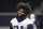 Dallas Cowboys running back Ezekiel Elliott smiles as he walks off the field after participating in drills at the team's NFL football training facility in Frisco, Texas, Wednesday, June 12, 2019. (AP Photo/Tony Gutierrez