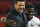 Tottenham Hotspur's Ivorian defender Serge Aurier (R) hugs Tottenham Hotspur's Argentinian head coach Mauricio Pochettino (L) at the end of the English Premier League football match between Manchester United and Tottenham Hotspur at Old Trafford in Manchester, north west England, on August 27, 2018. (Photo by Oli SCARFF / AFP) / RESTRICTED TO EDITORIAL USE. No use with unauthorized audio, video, data, fixture lists, club/league logos or 'live' services. Online in-match use limited to 120 images. An additional 40 images may be used in extra time. No video emulation. Social media in-match use limited to 120 images. An additional 40 images may be used in extra time. No use in betting publications, games or single club/league/player publications. /         (Photo credit should read OLI SCARFF/AFP/Getty Images)