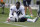 New England Patriots wide receiver Antonio Brown ties his shoe during an NFL football practice, Wednesday, Sept. 18, 2019, in Foxborough, Mass. (AP Photo/Steven Senne)