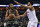 Memphis Grizzlies center Joakim Noah, left, handles the ball against Minnesota Timberwolves center Karl-Anthony Towns (32) in the first half of an NBA basketball game Saturday, March 23, 2019, in Memphis, Tenn. (AP Photo/Brandon Dill)