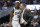 FILE - In this March 29, 2019, file photo, Michigan State guard Cassius Winston (5) puts his arm around coach Tom Izzo following the team's 80-63 win over LSU in an NCAA men's college basketball tournament East Region semifinal, in Washington. Winston has joined a select group of players in program history as an All-America player and Big Ten player of the year. If he can help the Spartans win two more games, he'll join Magic Johnson and Mateen Cleaves as the school's national championship-winning point guards. (AP Photo/Patrick Semansky, File)